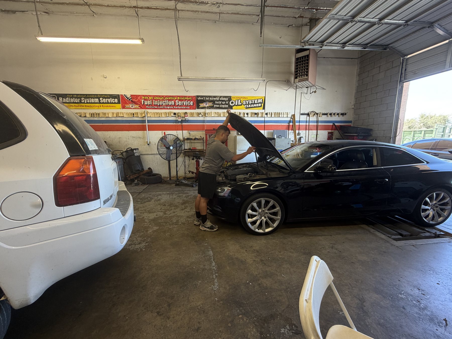 W & J Auto Care technician inspecting a customer's car